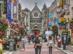 Famous shopping area in Dublin, Ireland.  Grafton Street showing shoppers, shops and church.